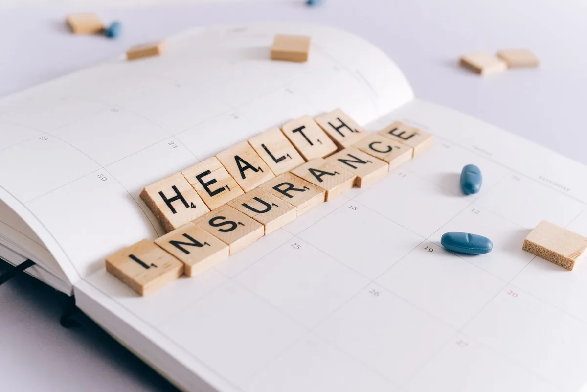 Person reviewing health insurance documents and benefit statements
