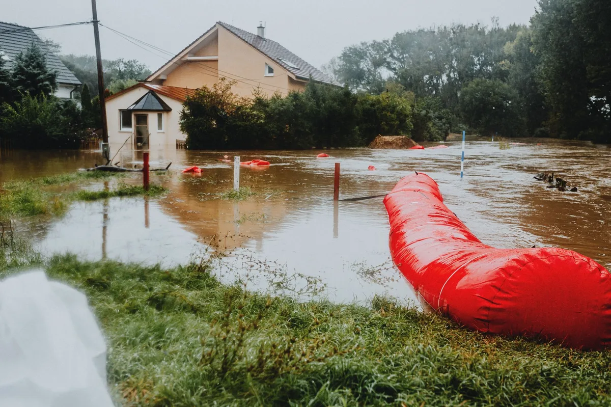 Flooded street with water reaching building foundations during severe weather