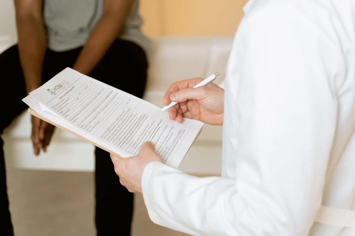 Medical professional reviewing health insurance documents with patient