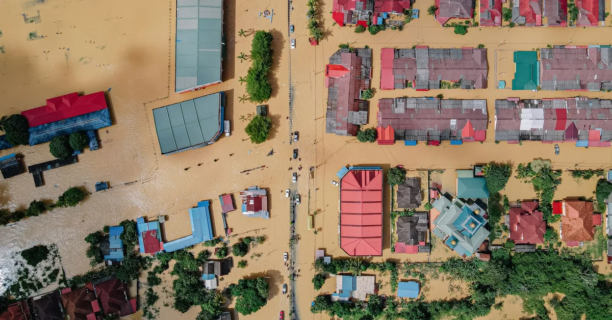 Flooded residential street with homes partially submerged in water