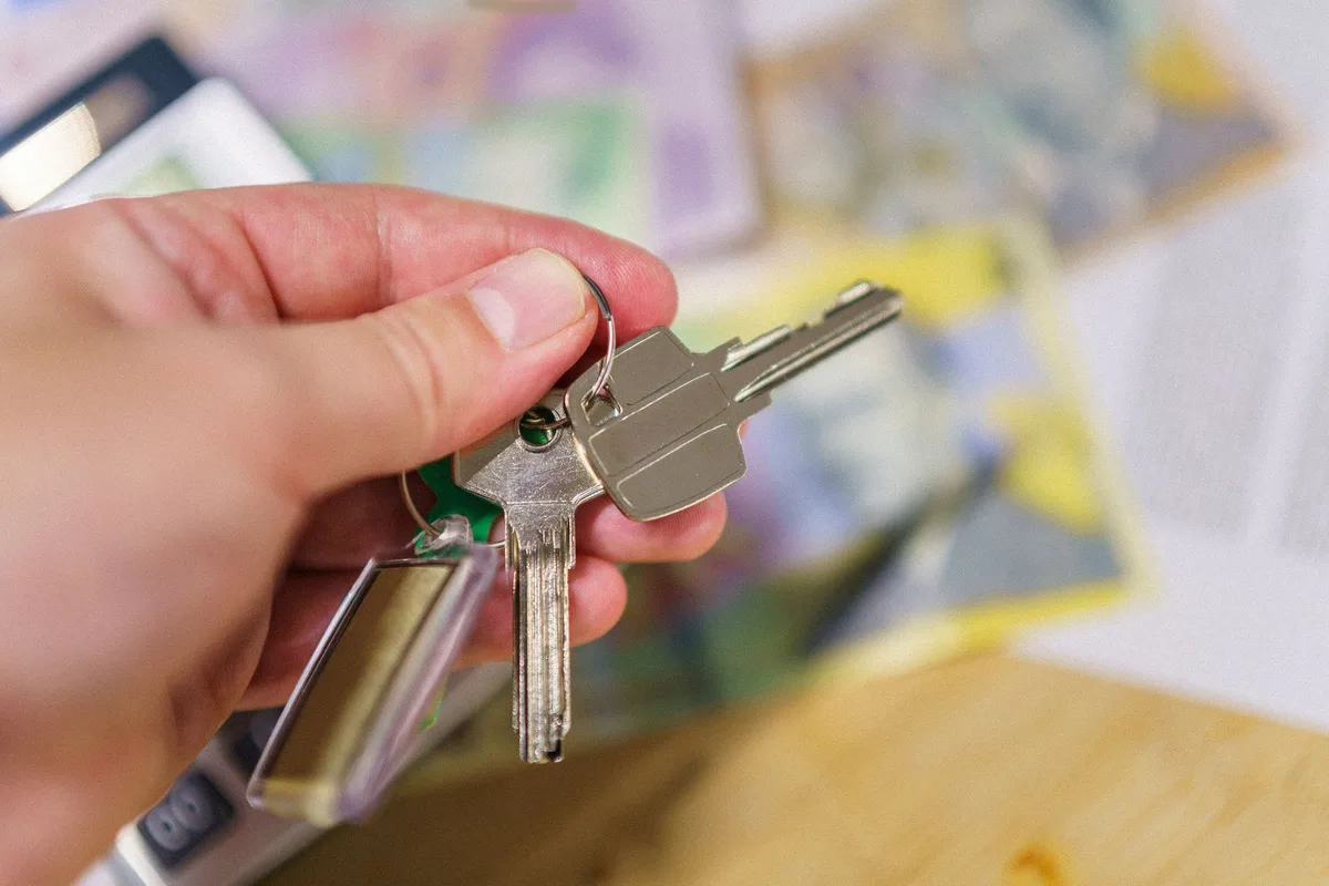 House keys and signing documents representing landlord insurance and investment property ownership