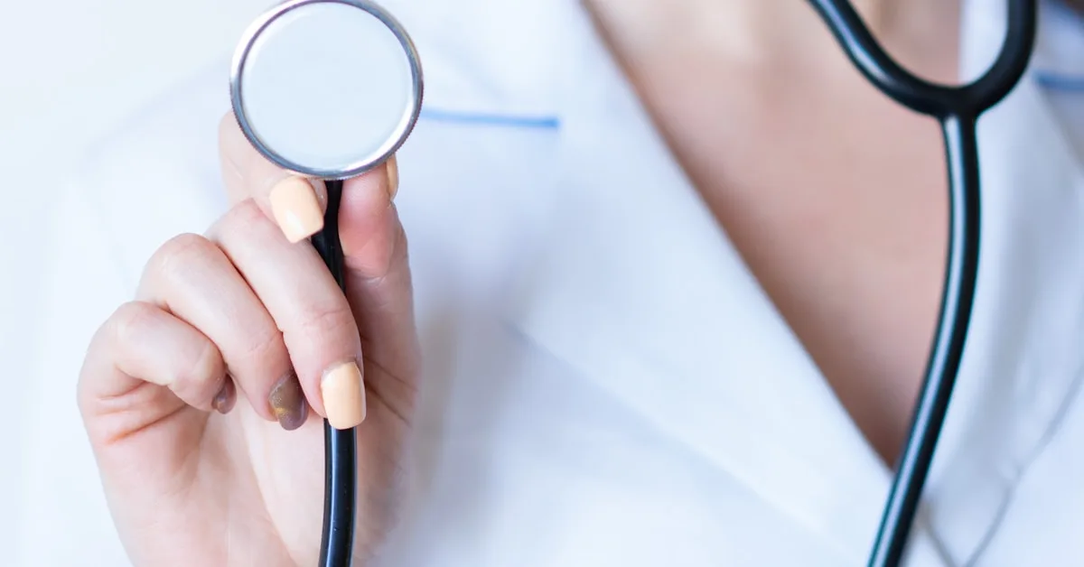 A stethoscope resting on clinical documents at a desk in an Australian medical centre.