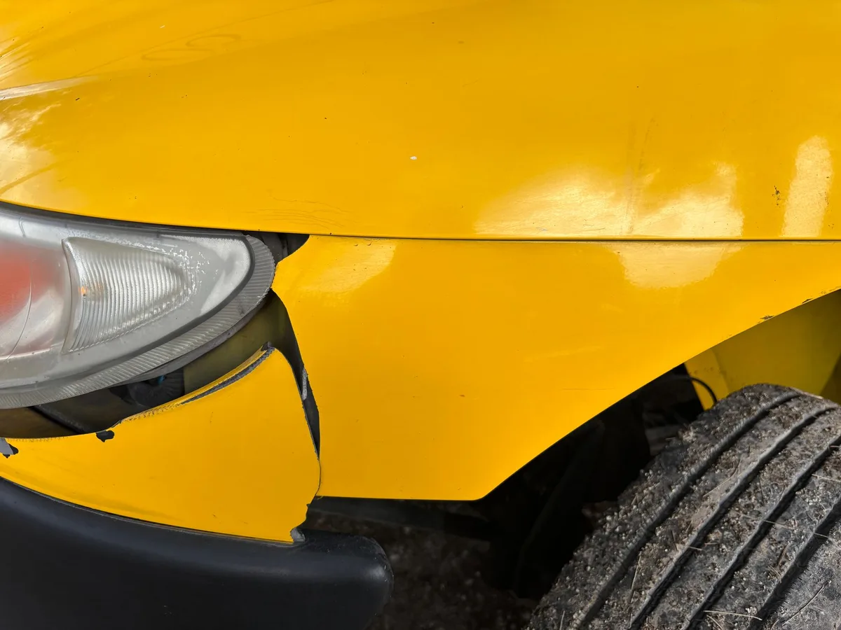 Car insurance documentation and vehicle on the road