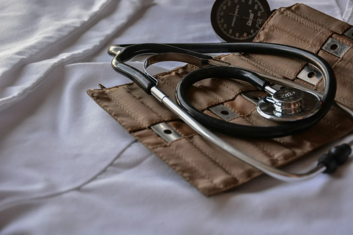 Medical stethoscope resting on healthcare documents
