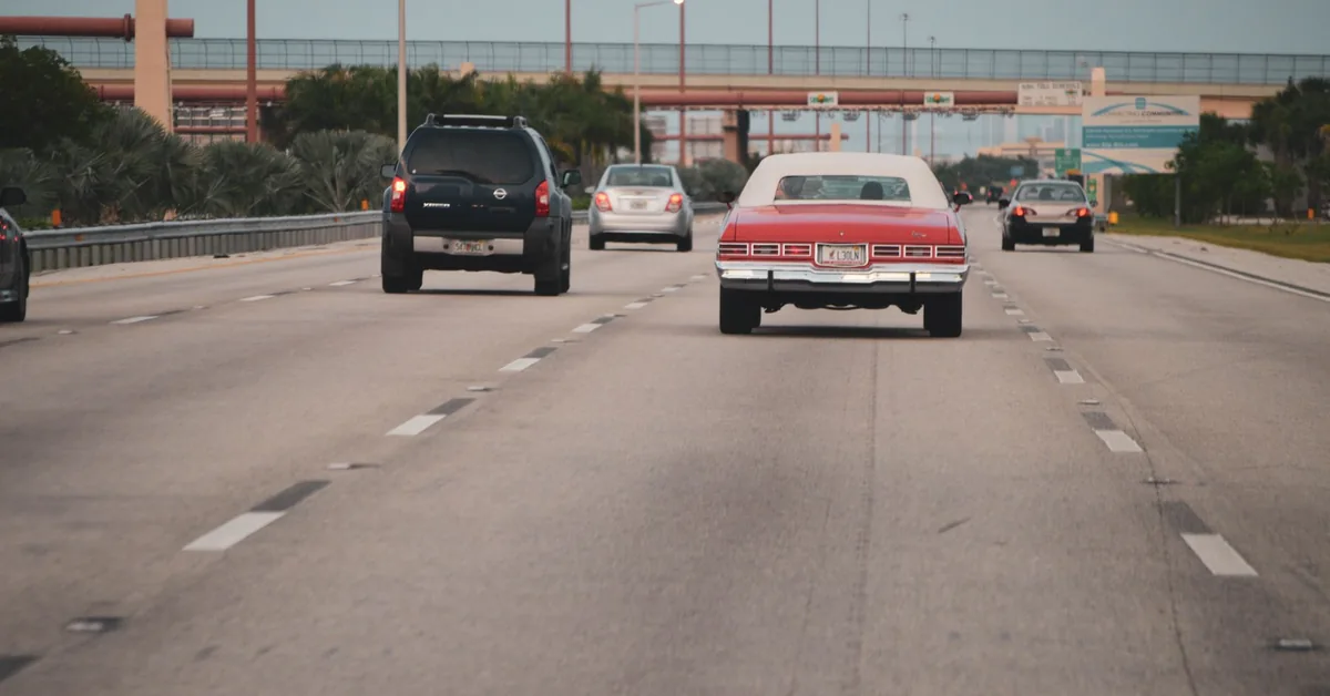 Car driving on an open road representing safe driving and no-claim bonus eligibility