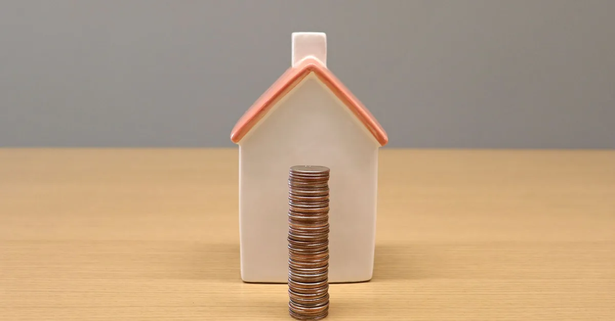 A home insurance document beside house keys on a table
