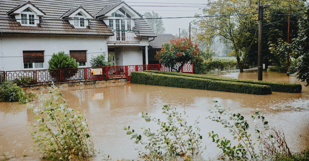 Flood water covering a street after heavy rain.
