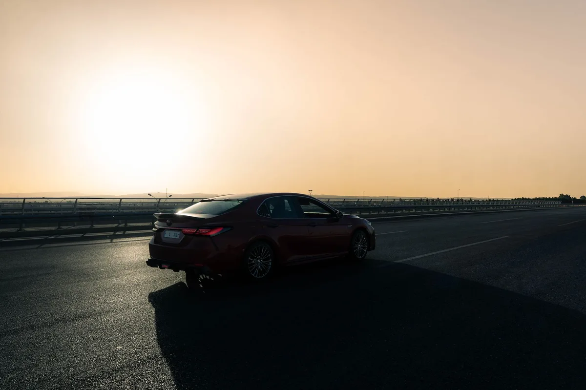 A modern car driving on a highway representing Ontario auto insurance changes