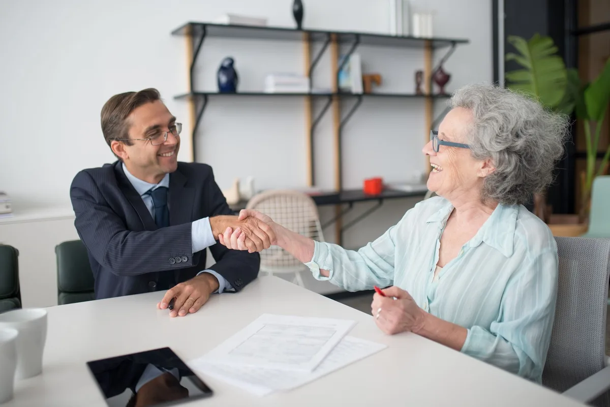 Professional business discussion between advisor and client at office desk