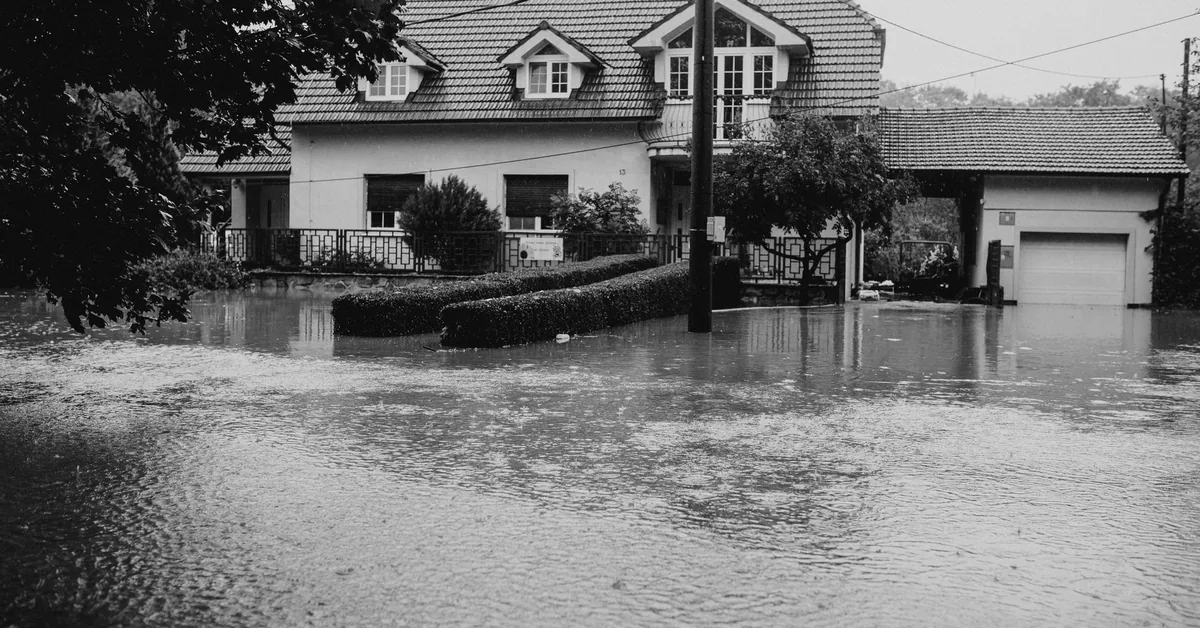 Insurance policy documents and contract signing representing flood coverage endorsement