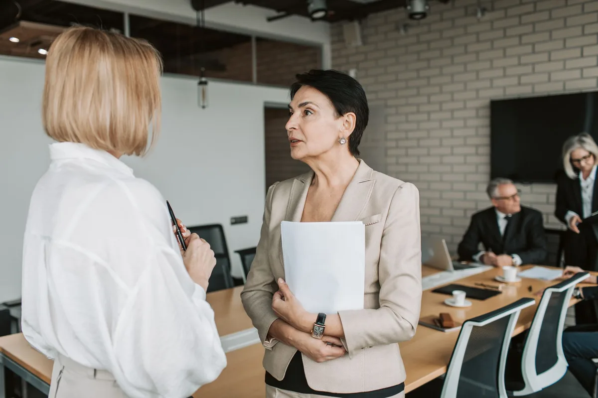 Professional workplace discussion about employee benefits and coverage