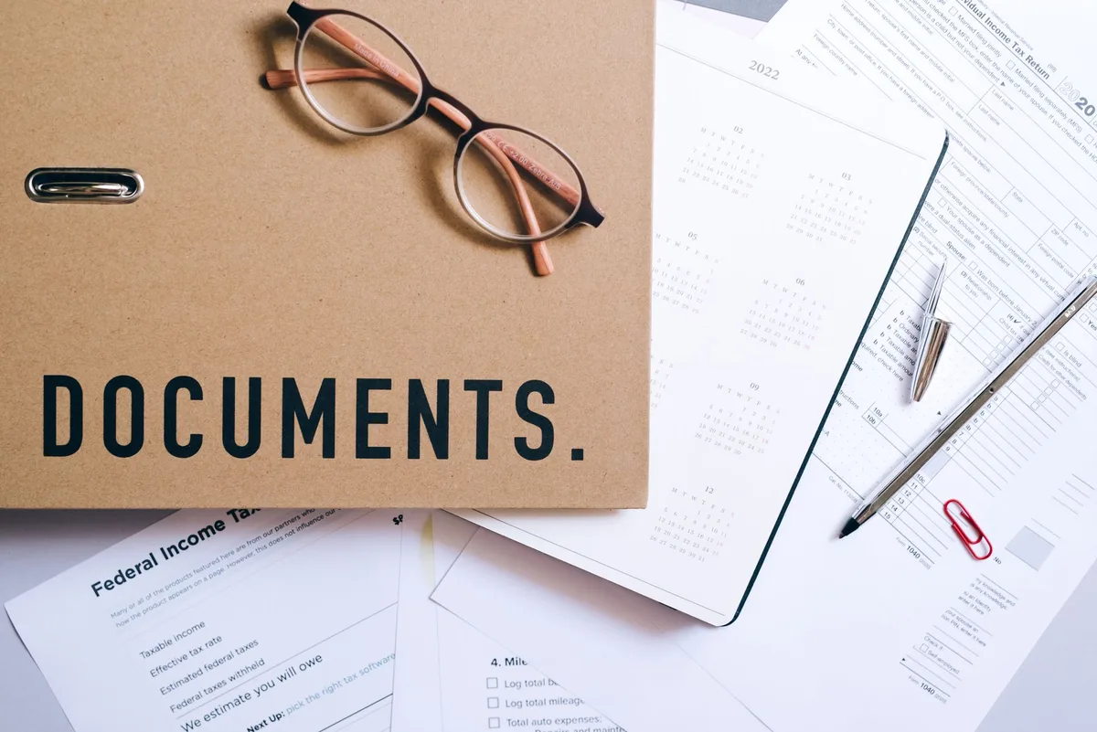 Regulatory documents and pen on desk representing insurance oversight