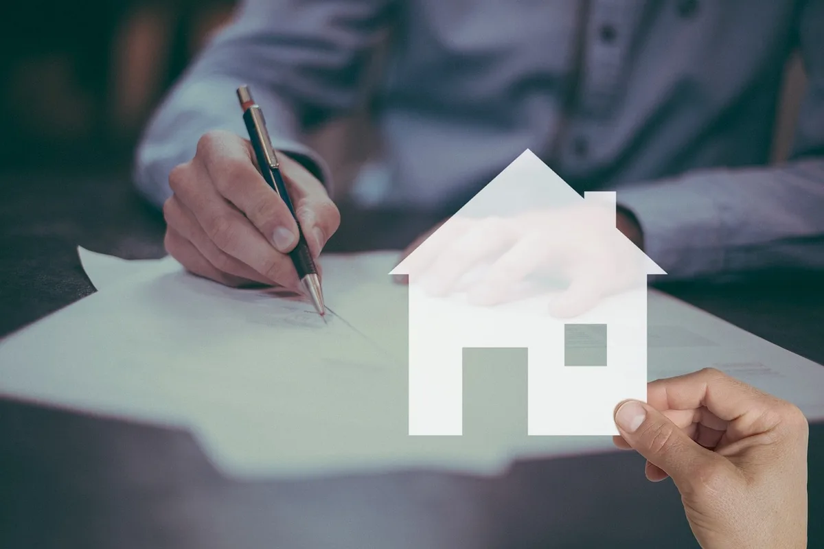 House keys and signing documents on a table, representing rental property agreements