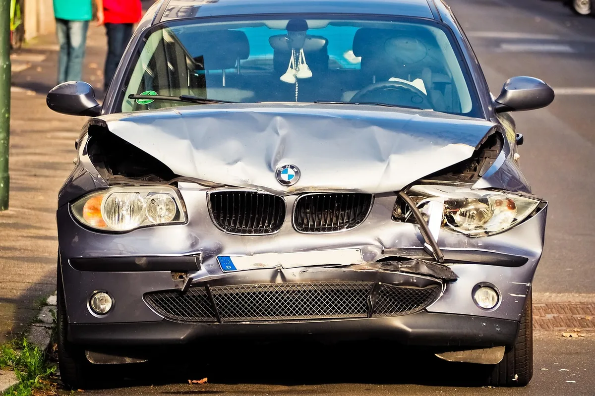 Car insurance documentation and vehicle keys on a desk