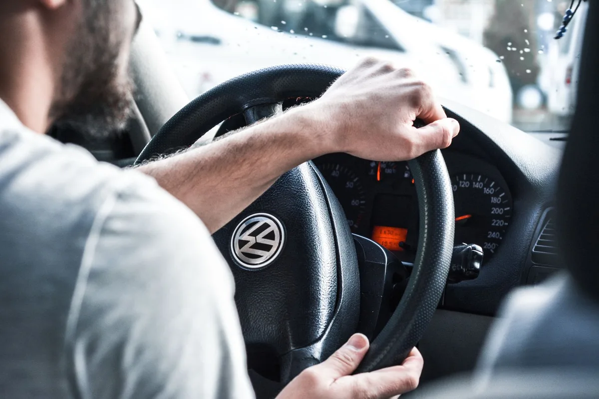 Person driving a car on a UK road