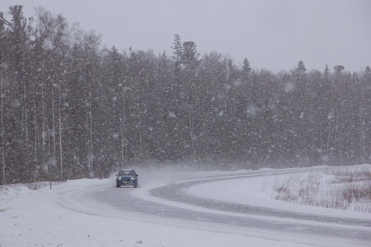 Car driving on a wet road in challenging conditions