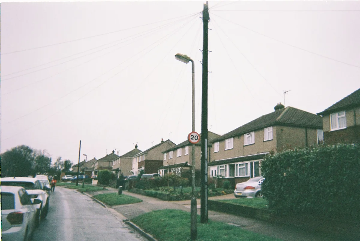 A residential street with modern UK homes illustrating the property market