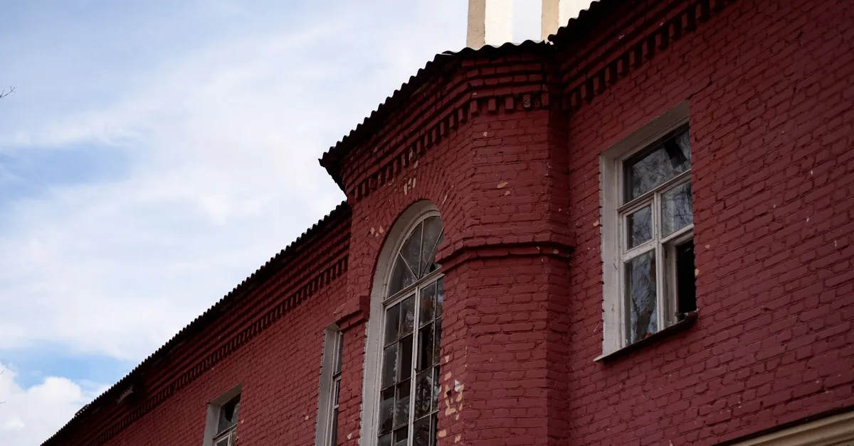 Person signing an insurance policy document for buildings cover