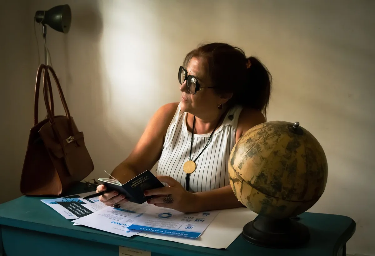 Documents and pen on a desk representing travel insurance planning