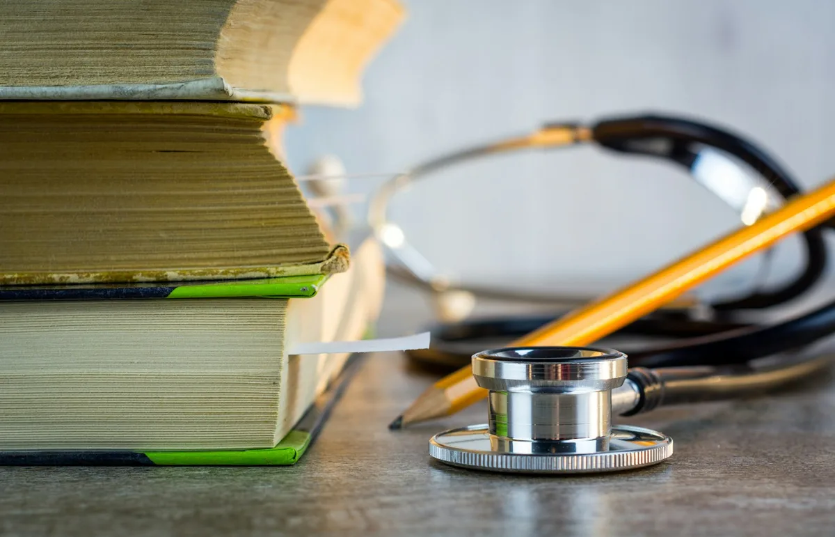 Medical stethoscope and health insurance documents on a desk