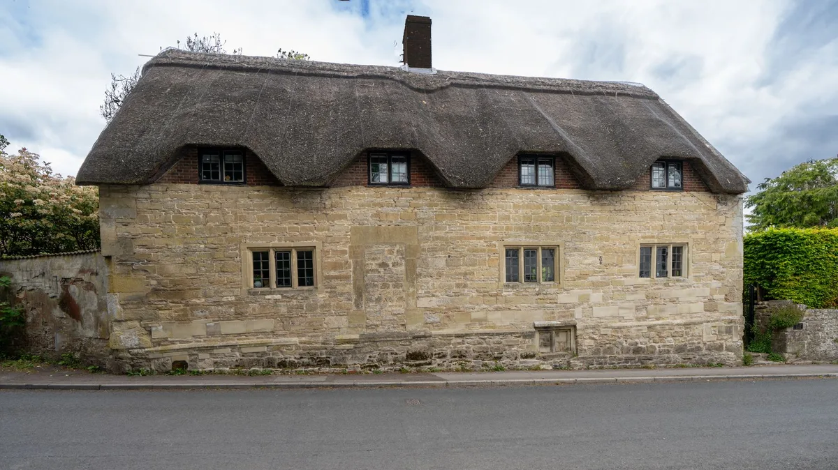 Traditional house exterior with pitched roof in residential neighbourhood