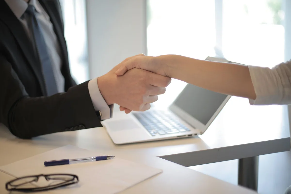Business handshake between employer and new employee