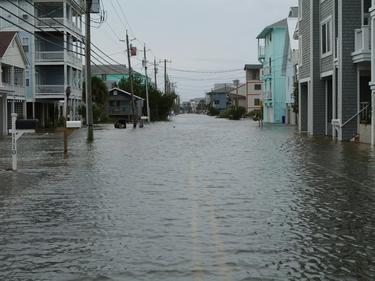Flooded street and homes during a hurricane with rising water levels