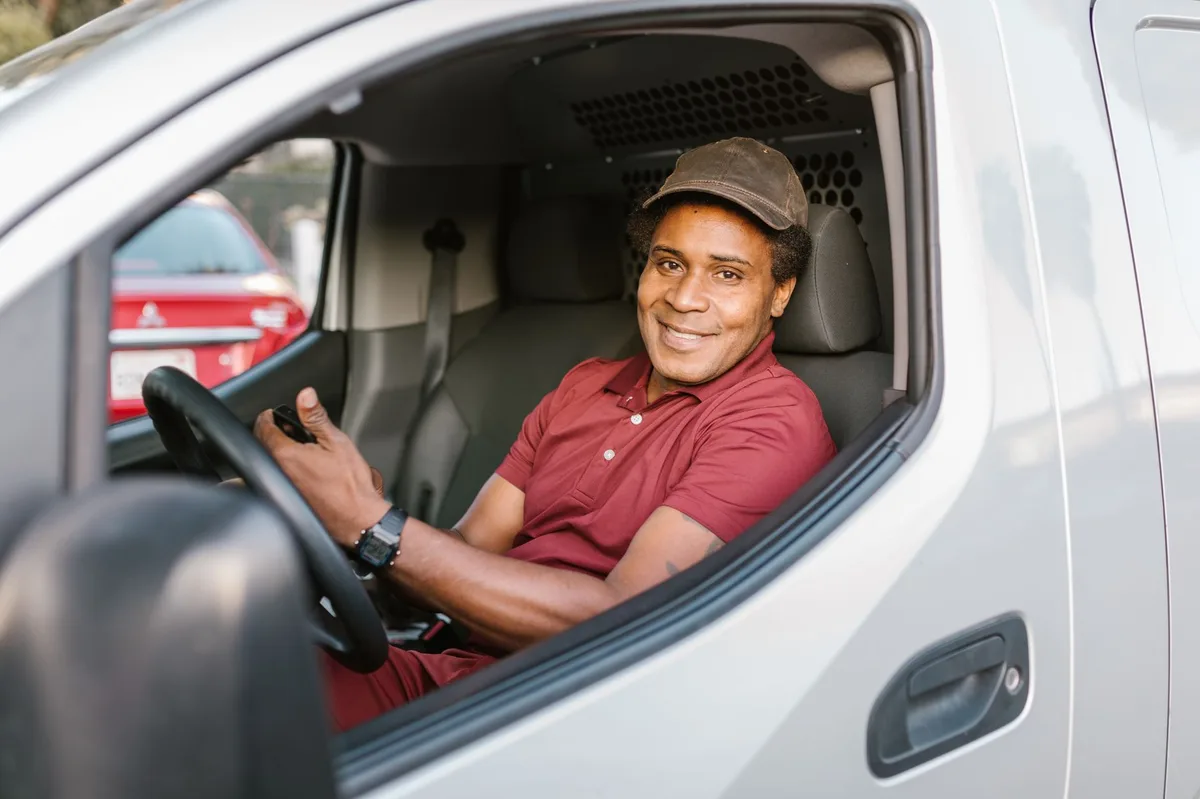 Person reviewing car insurance documents with vehicle keys on desk