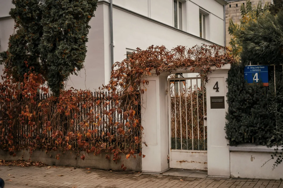 Single-family home exterior in autumn, representing seasonal home maintenance and insurance preparation