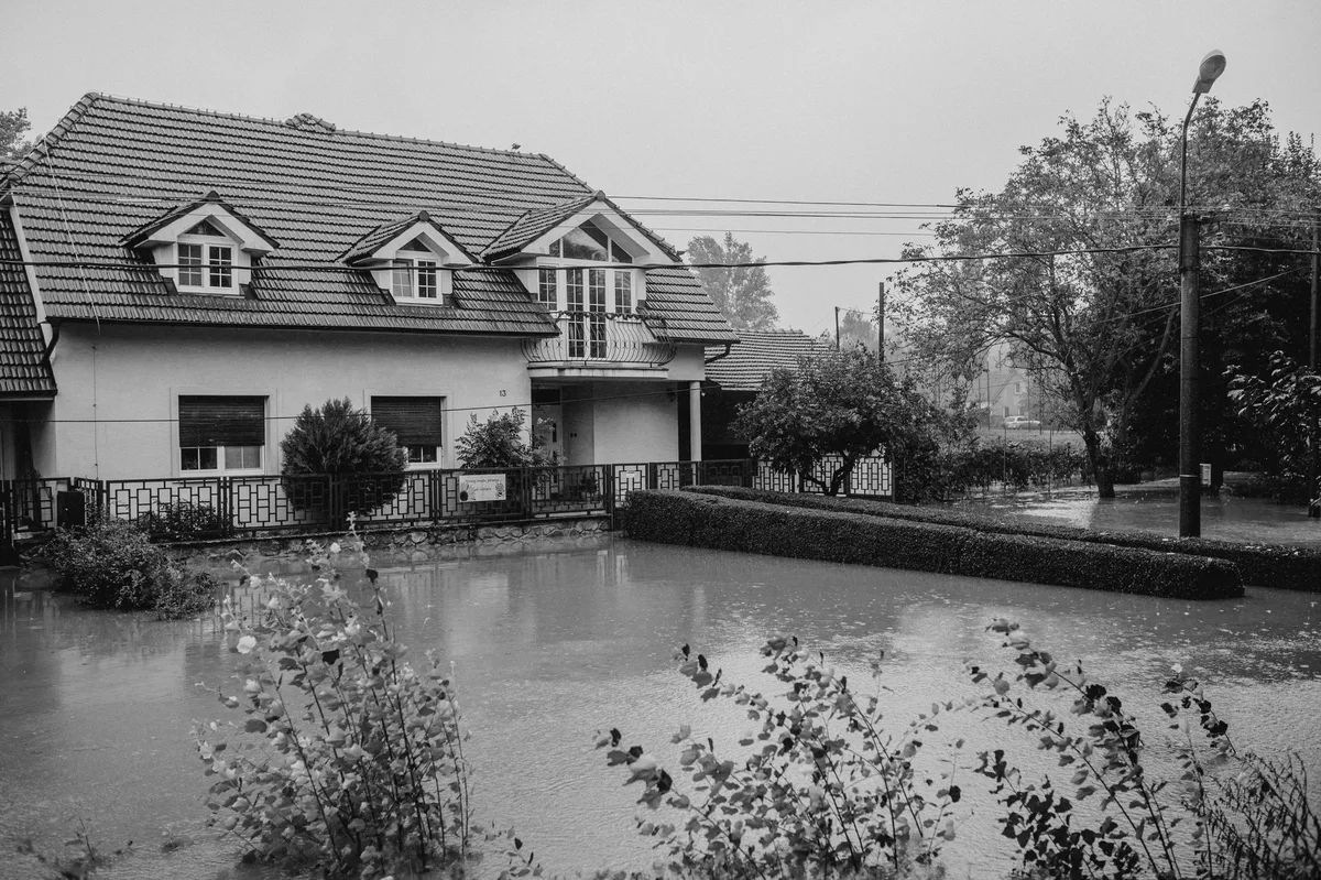 Flooded residential area with standing water surrounding homes