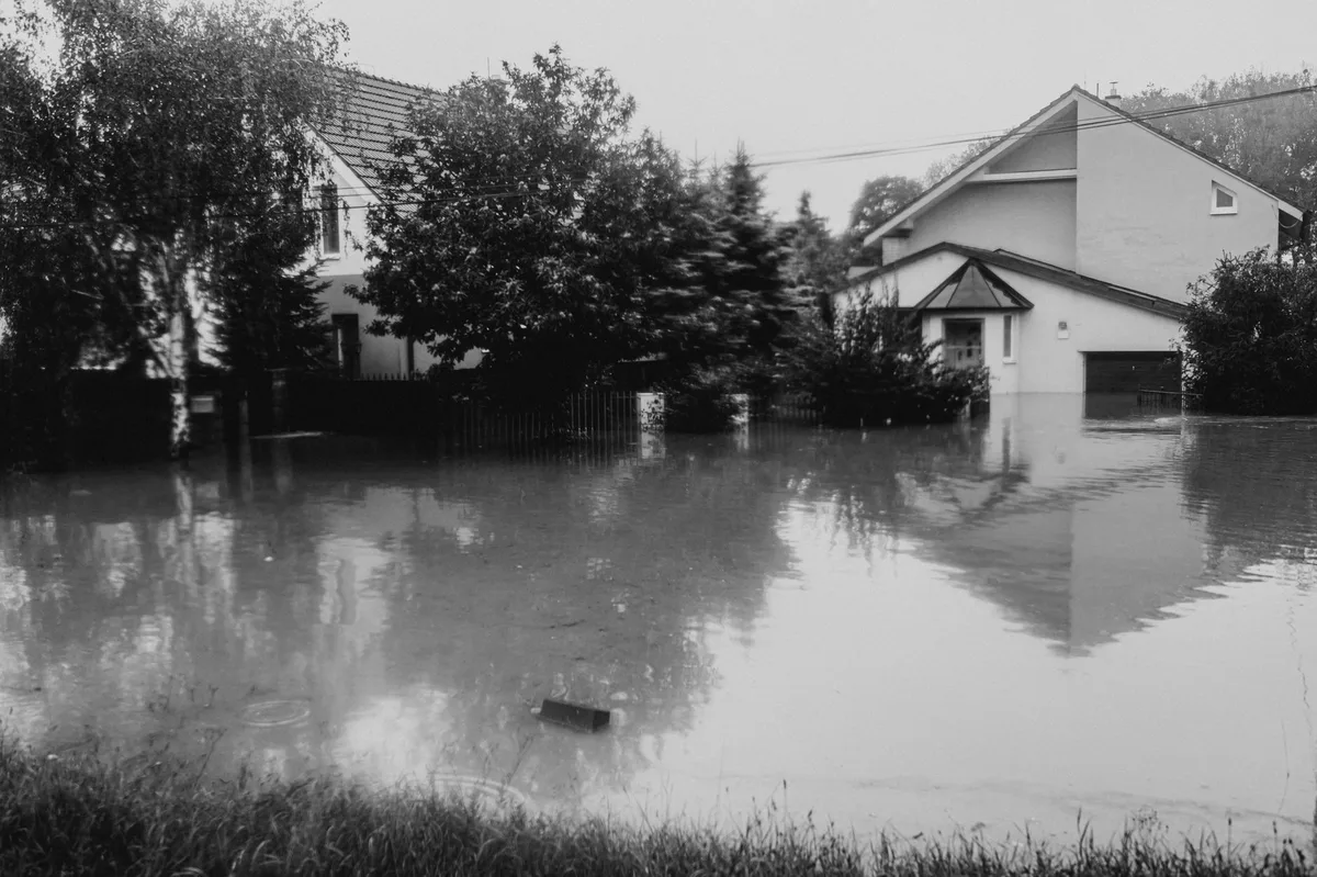 Residential street flooded with water after heavy rain