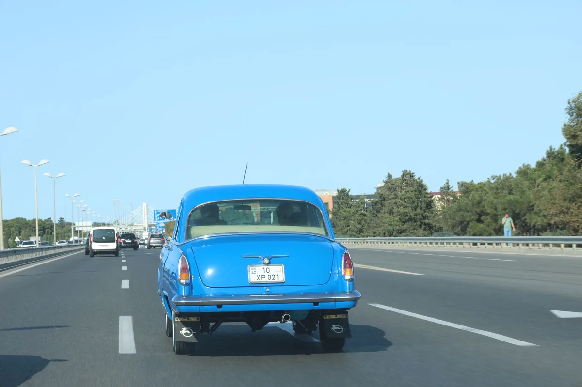 Car driving on a sunny road during summer.