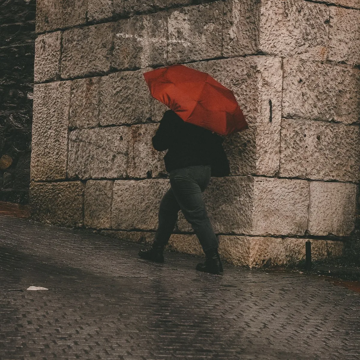 Red umbrella protecting against rain, symbolizing liability coverage protection