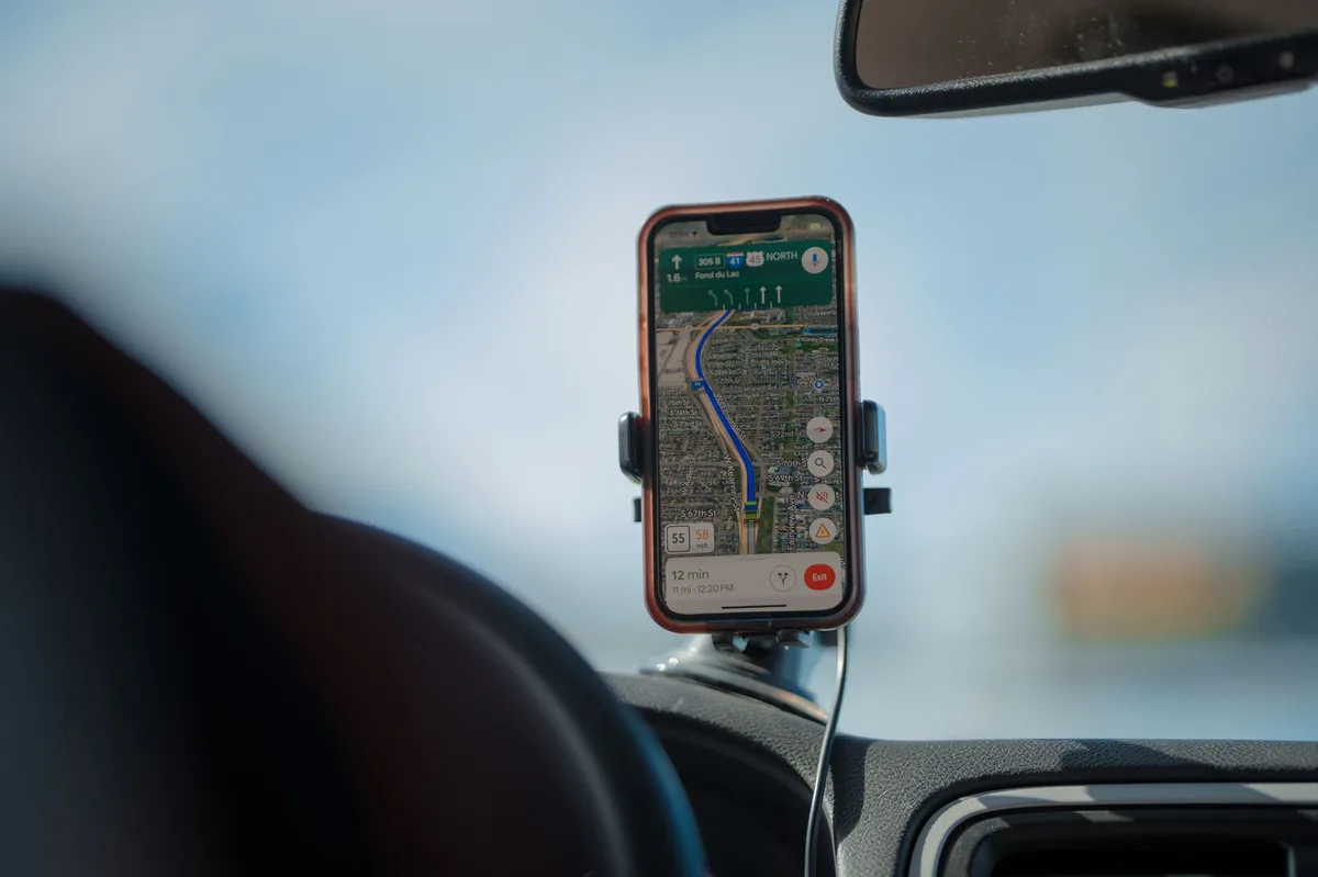 Driver behind the wheel of a car monitoring safe driving habits